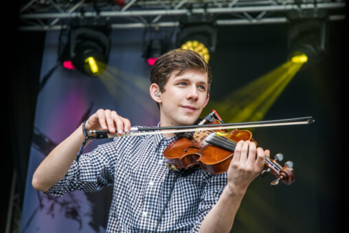Alastair Barron, Man with Brown Hair on stage playing fiddle