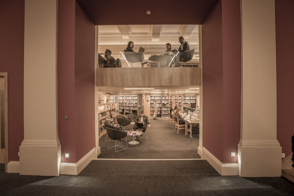 View of students reading in a library on two floors