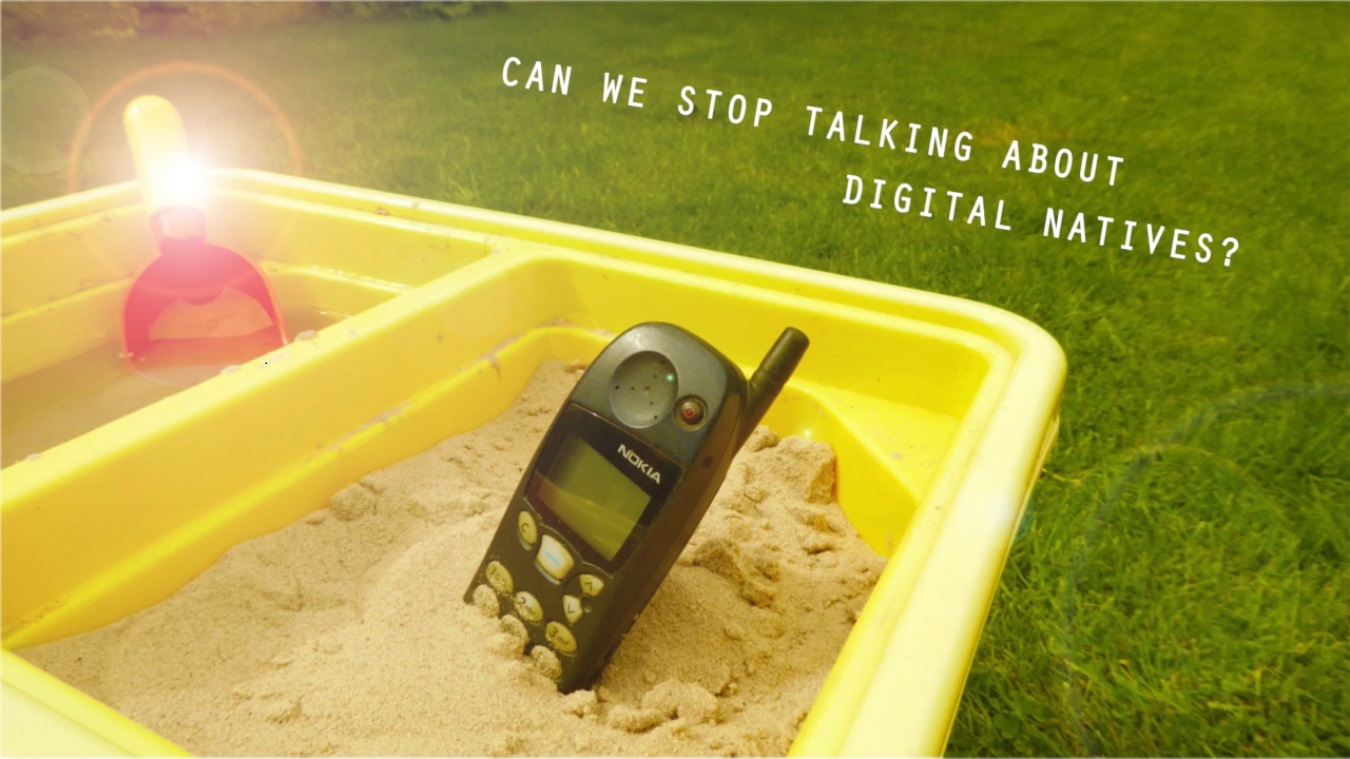 Old Nokia mobile phone, buried in a tray of sand
