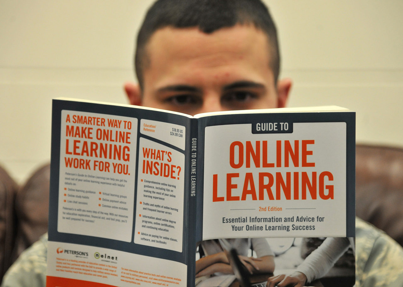 A US airman reading a book about online learning