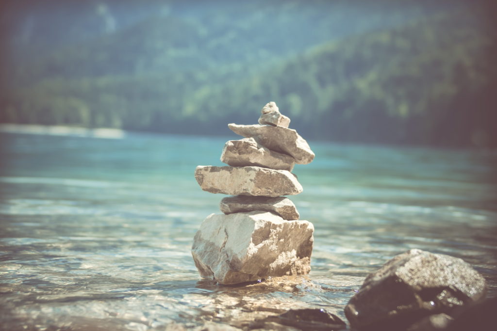 A stack of balanced rocks in a lake