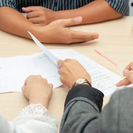 Shot of an interview table with notes and hands