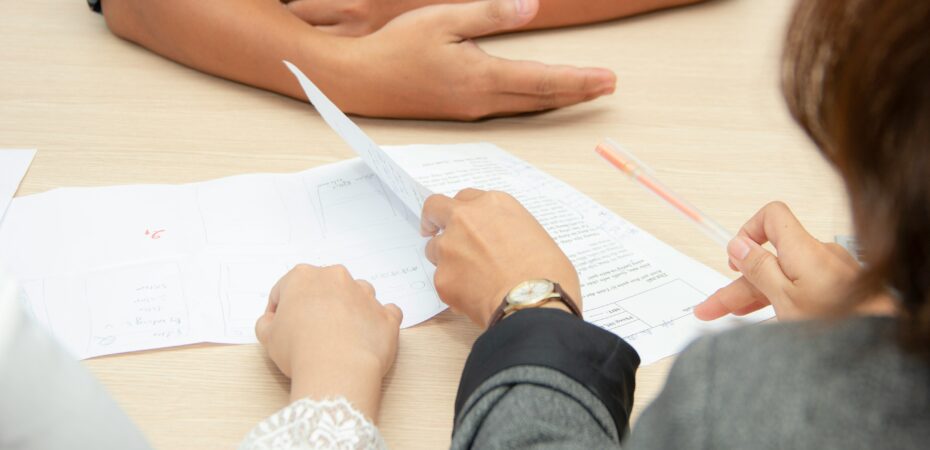 Shot of an interview table with notes and hands