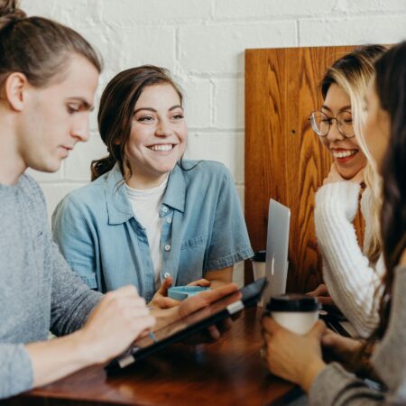 People with devices and coffee talking
