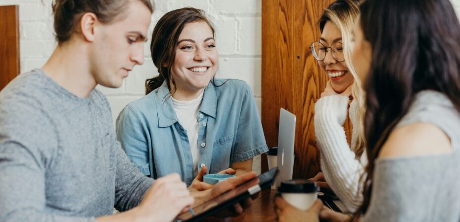 People with devices and coffee talking