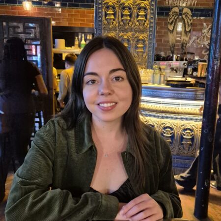 Headshot of a lady sat at a table.