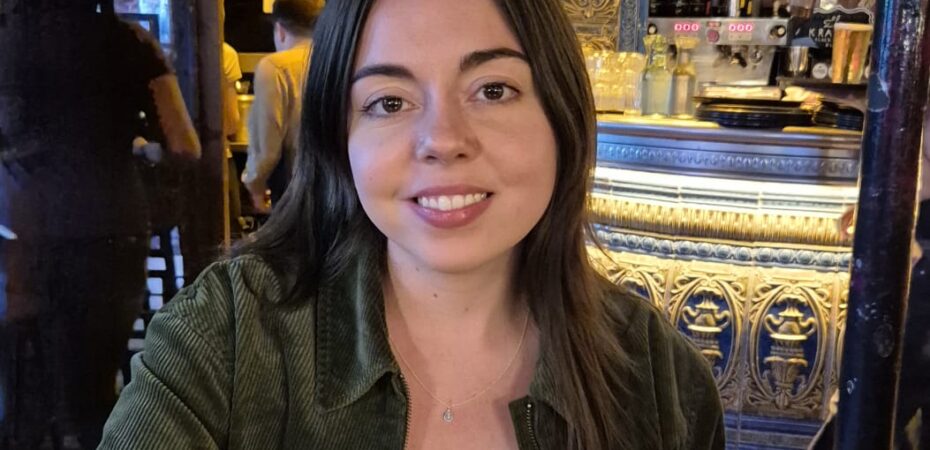 Headshot of a lady sat at a table.