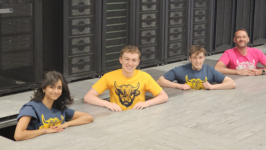 Left to right: Vaidehi, Alistair, James and EPCC Director of HPC Systems Paul Clark demonstrate a raised floor in the ACF. ARCHER2, seen in the background, is hosted in this computer room.