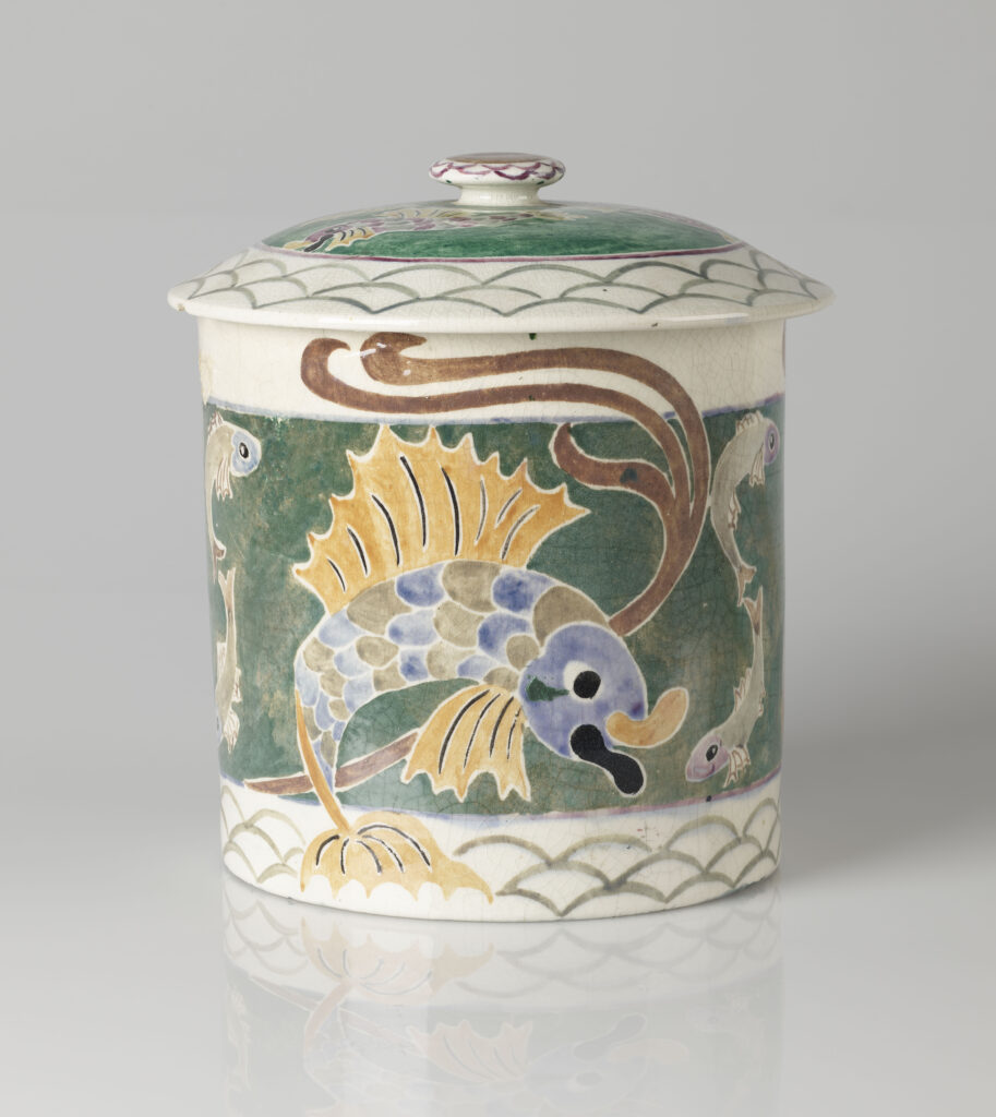 Image of a glazed barrel vessel witha lid, decorated with a Japanese inspired style koi fish. 