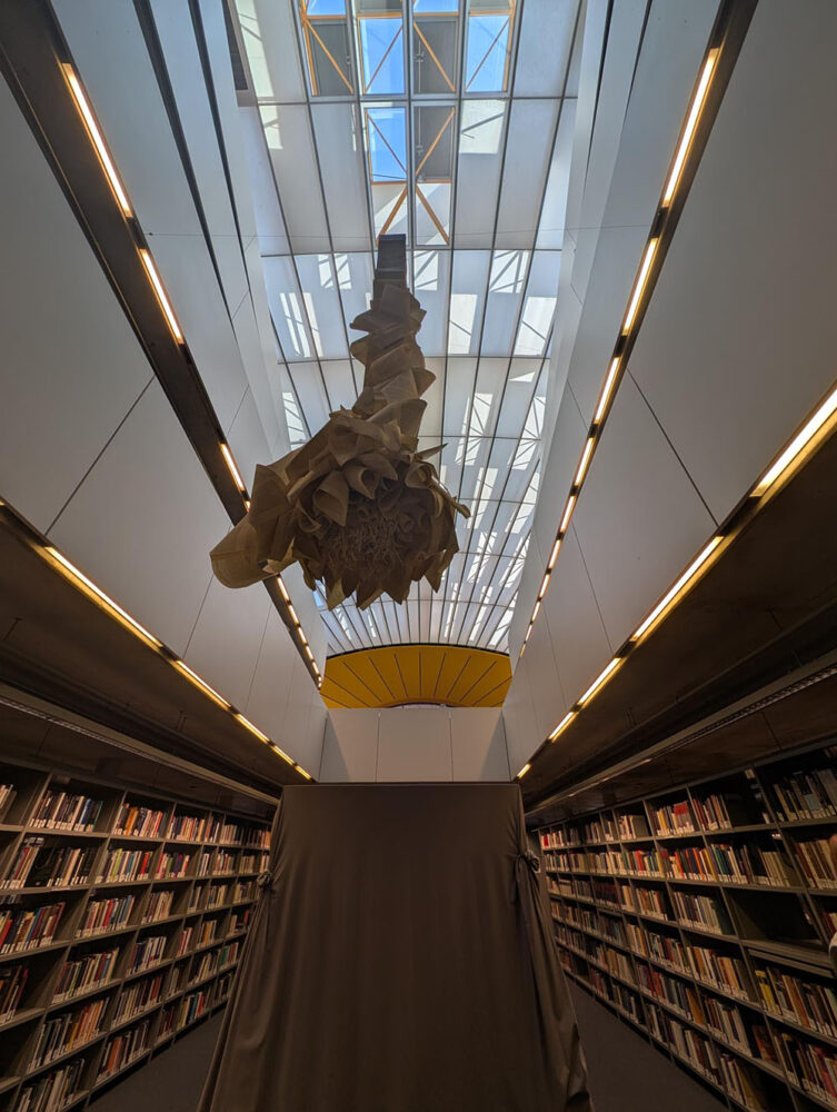 Internal view of the Freie Universität Berlin Philological Library, showing a ceiling art sculpture and bookshelves