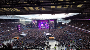 Stadium concert setting with stage and crowd