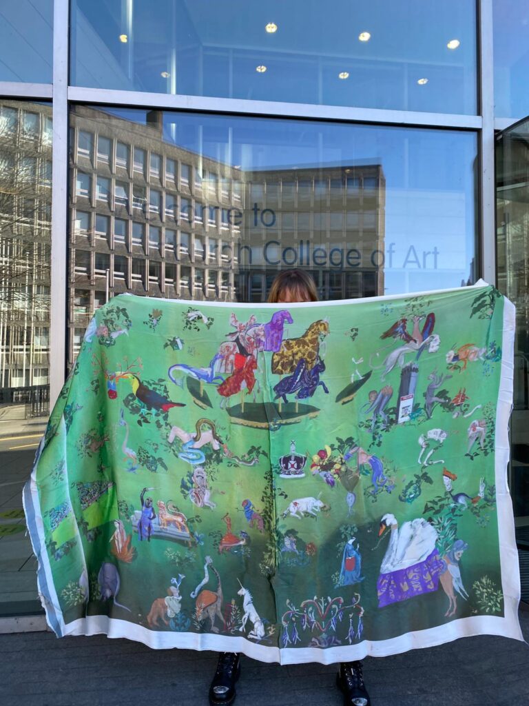 Student Camila holding up her digitally printed fabric length outside of the ECA building