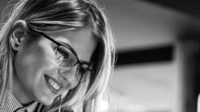 Smiling woman with glasses.