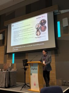 Man on stage presenting a slide about AI training