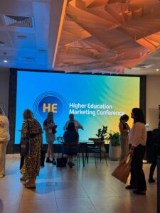 Digital screen with "Higher Education Marketing Conference" logo