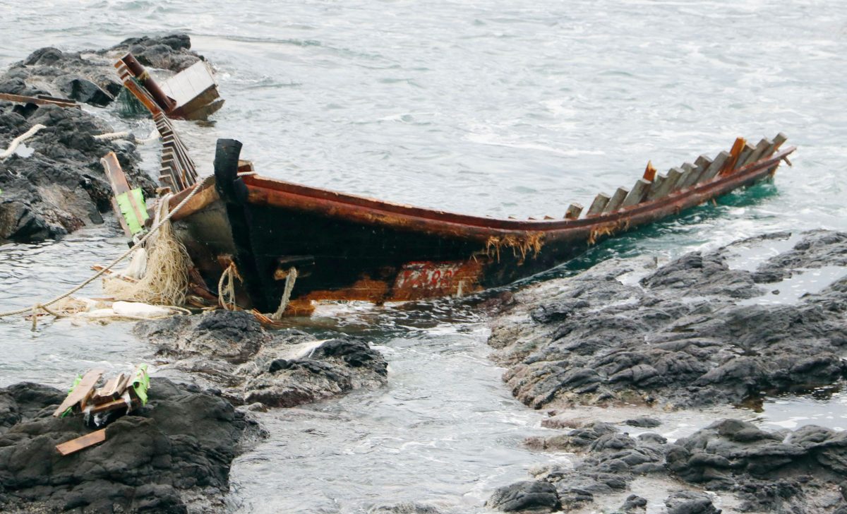 A colour photograph of a North Korean "ghost ship" on the shore of Oga Prefecture, Japan.