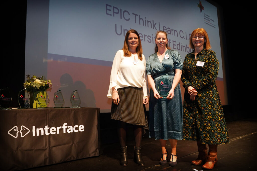 sinead, iona and presenter on stage