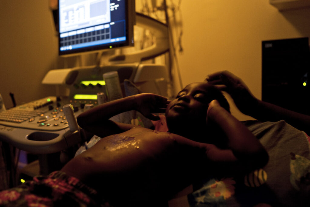 Young patient mid check up with computer screen in background
