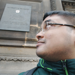 Image of a graduate looking at an Edinburgh Medical School commemorative plaque