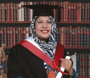 Portrait image of Sidra Gillani with shelves of books in the background