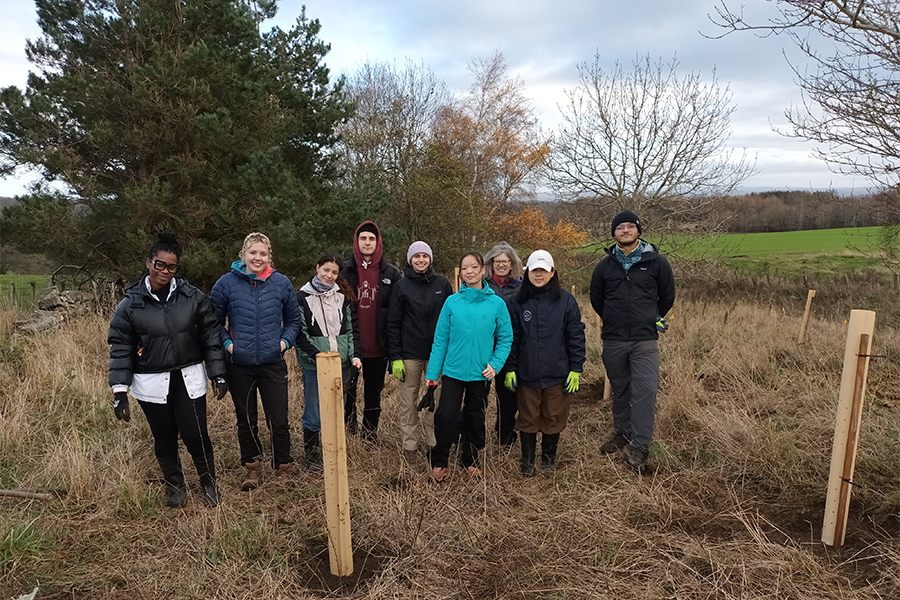 Staff and students planting trees at Rullion Green. (Credit: University of Edinburgh)