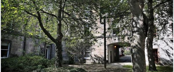 image of old building courtyard with trees