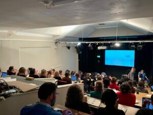 attentive audience listens to talk in lecture theatre