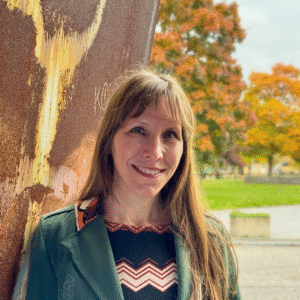 person with long hair and fringe in front of tree
