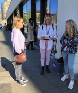 User researchers chat with a student in the street