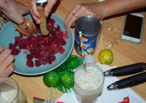 Students are making cocktails. Fruit and a drink on the table.