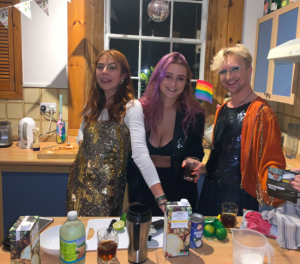 Three students are dressed up for the cocktail masterclass.