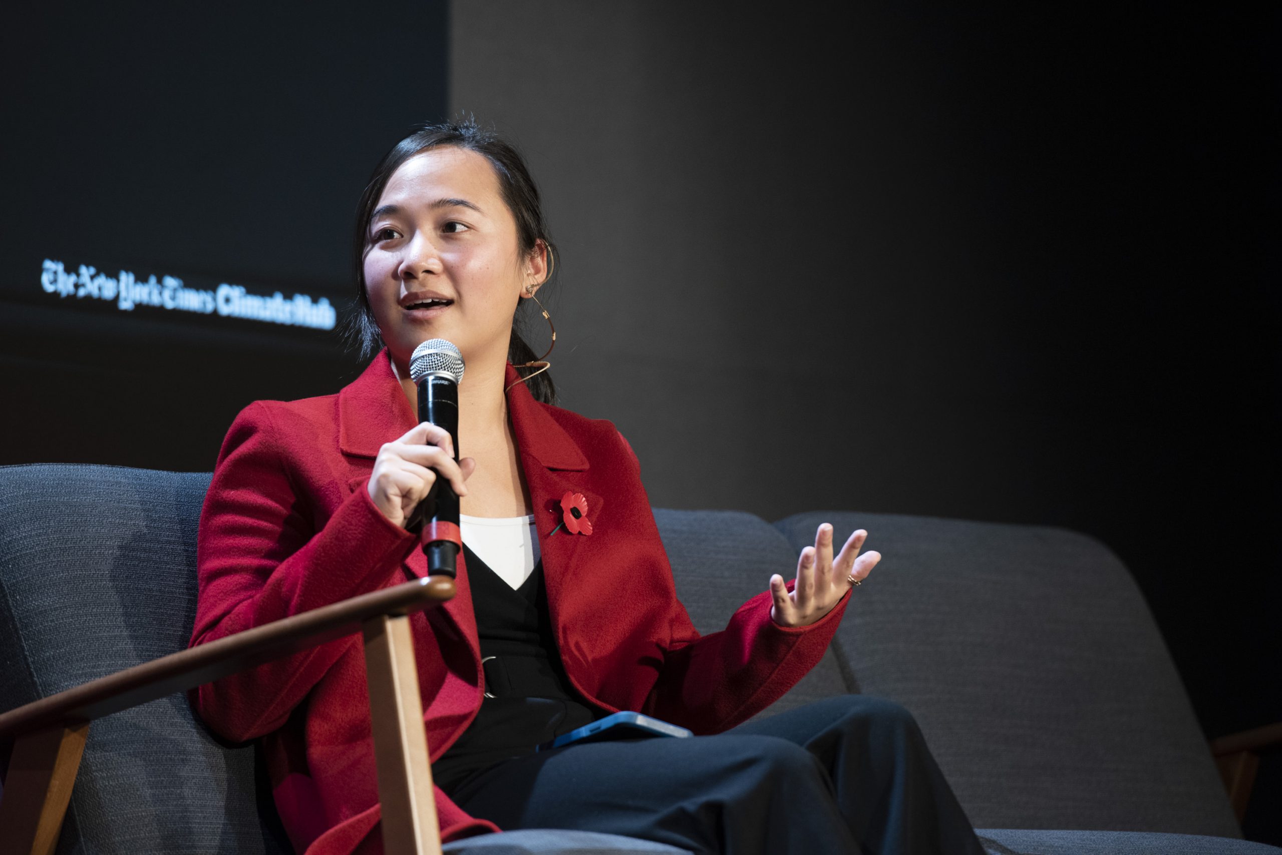 Picture of Lauren at the New York Times Climate Hub, holding a microphone