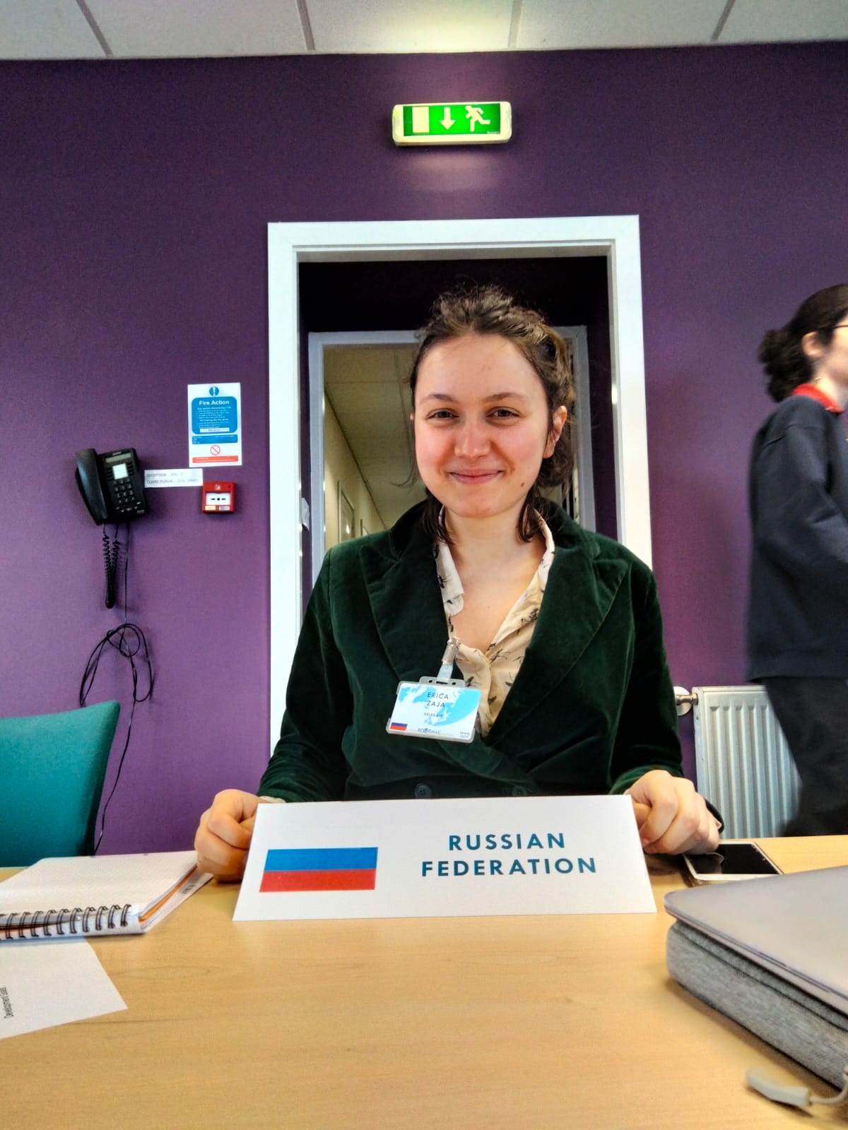 A photo of Erica sitting at a desk.