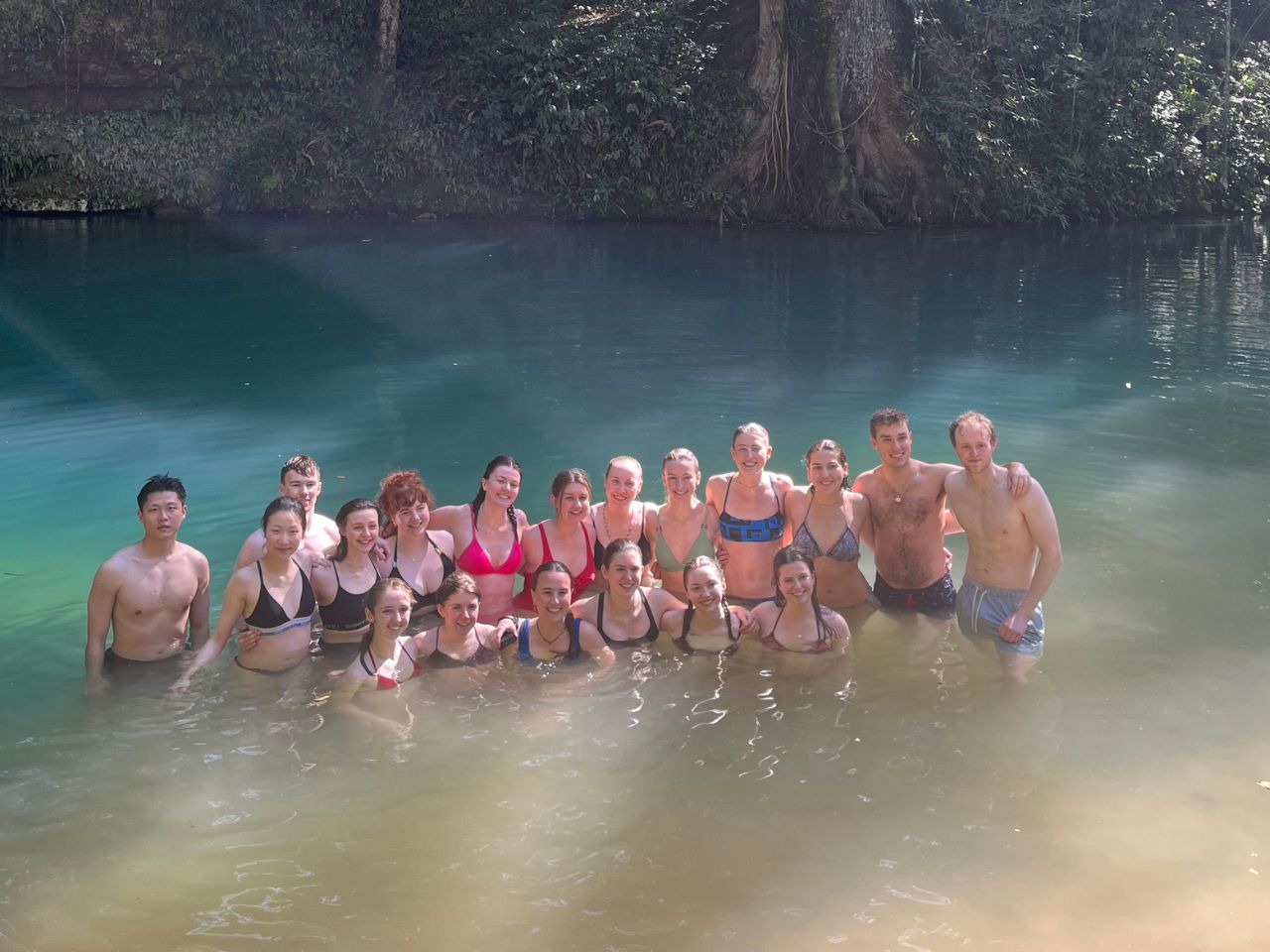 Group photo of BSc Environmental Geoscience students in a blue lagoon, Jamaica field trip.