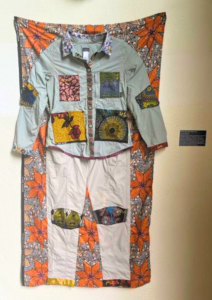 Sewing artwork depicting collaborative fieldwork in Africa - beautiful prints sewn onto a field work outfit.