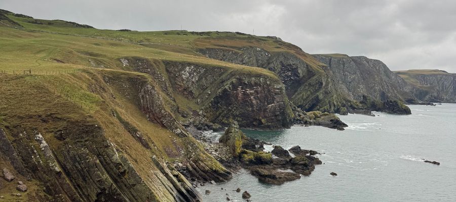 A rugged landscape with cliffs by the seaside