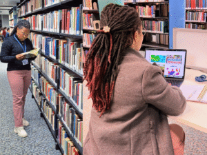 A combination of two images, one shows Jeanette reading a book in the library next to the shelves, and the second image shows her on a laptop, also in the library