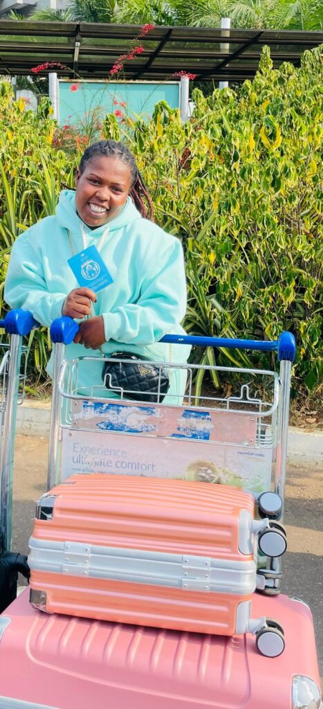 Jeanette holds her passport up to the camera, and is shown with her luggage