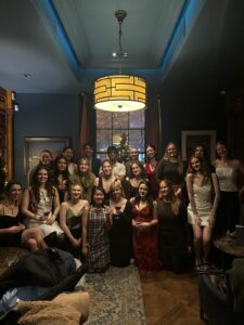 A group of people posing for a photo with a Christmas tree in the background