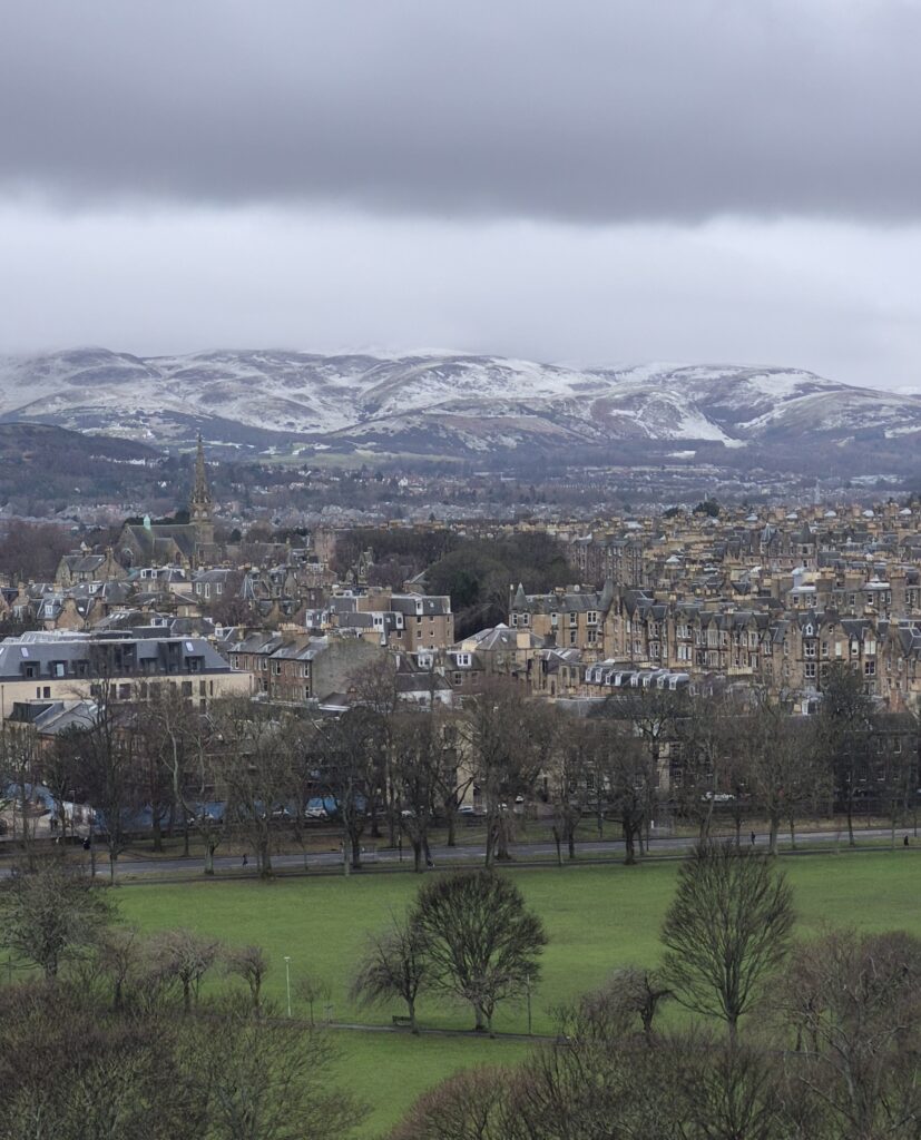 Snow has settled on the hills which tower above the city of Edinburgh