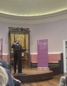 Professor Cornel West speaking at a podium in St Cecilia's Hall