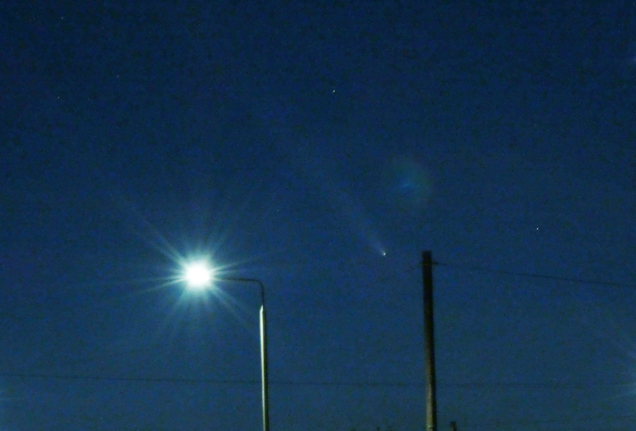 Night sky with streetlamp, telephone pole and faint comet