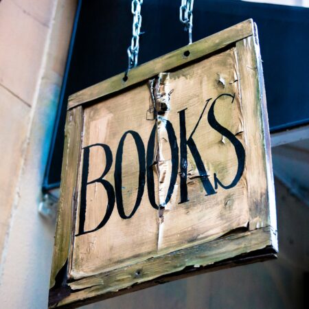 Old fashioned sign on shop saying books.
