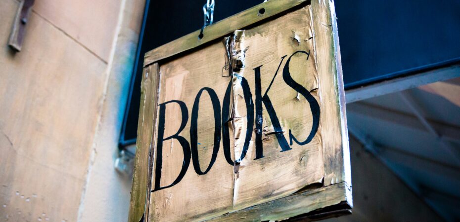Old fashioned sign on shop saying books.