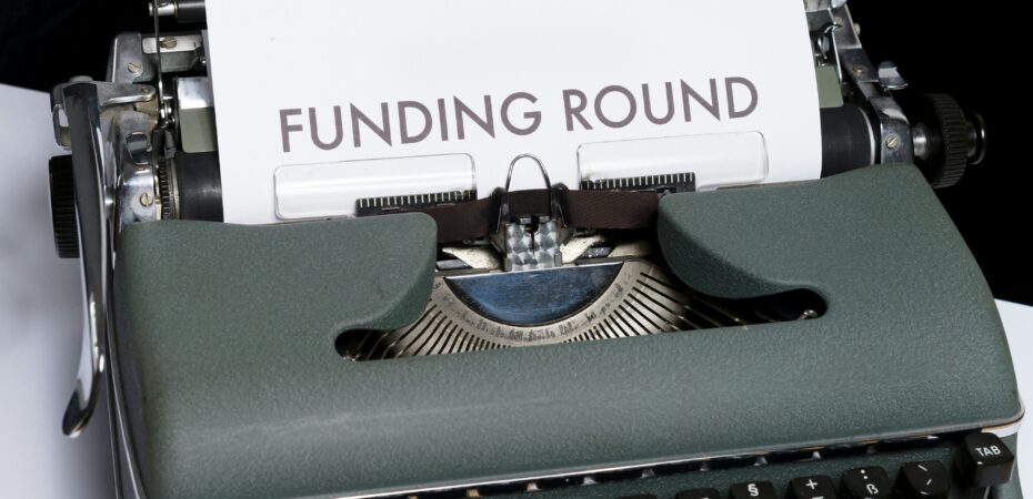 Typewriter with page reading the words Funding Round