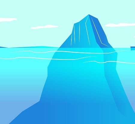 An iceberg or mountain with only it's peak sticking out of the surface of the ocean