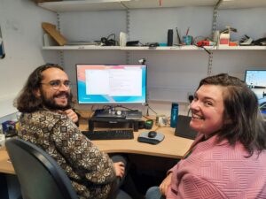 Two technicians in front of a computer