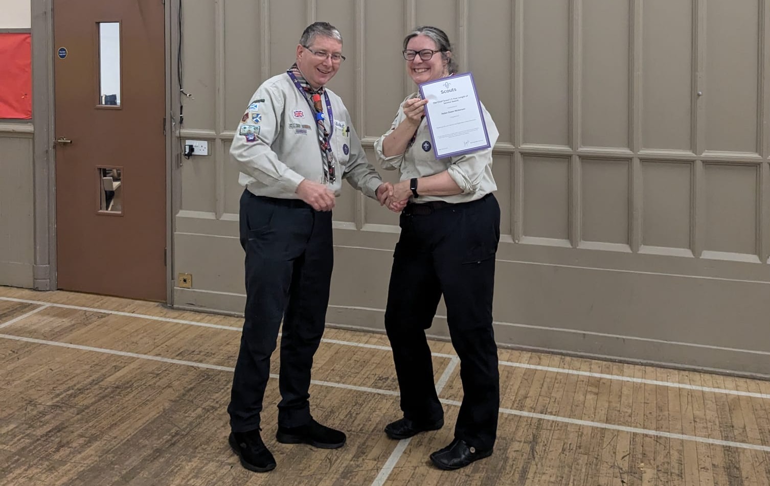 Helen Nickerson receiving a certificate in her cub leader uniform