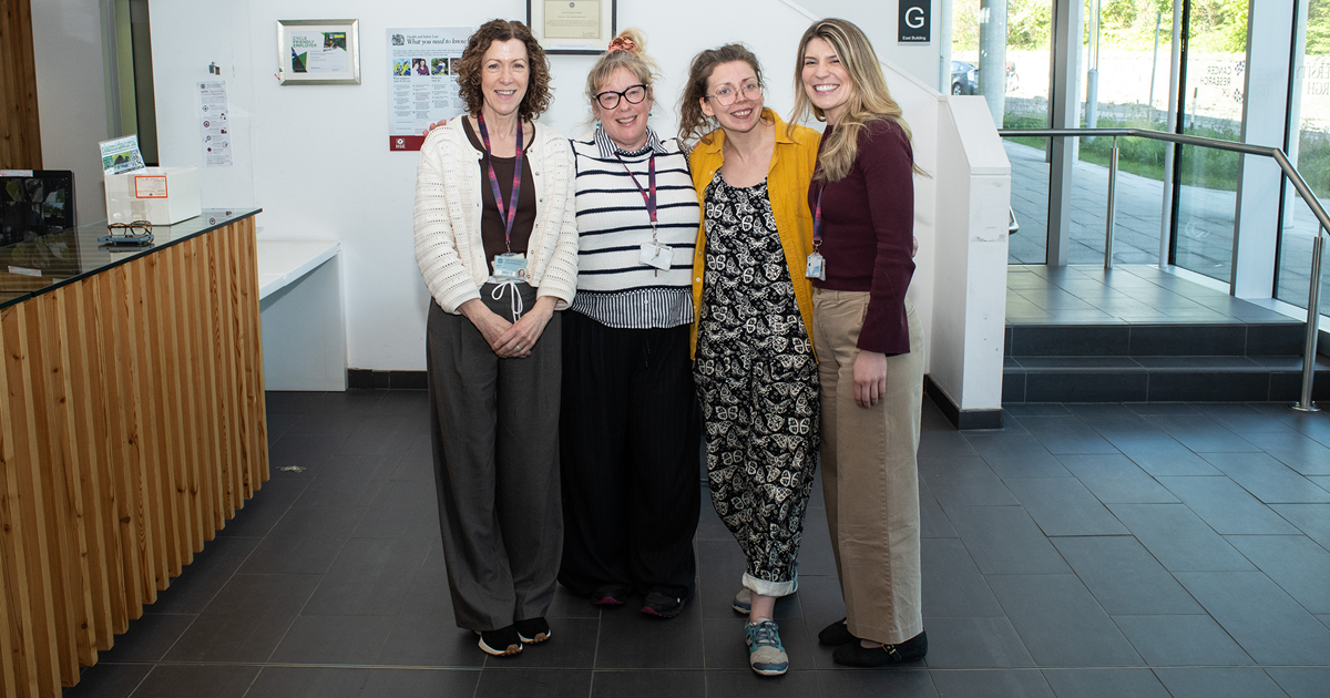 Four women standing in a row
