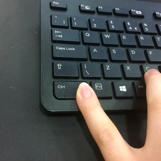 Keyboard with a left hand on a desk.